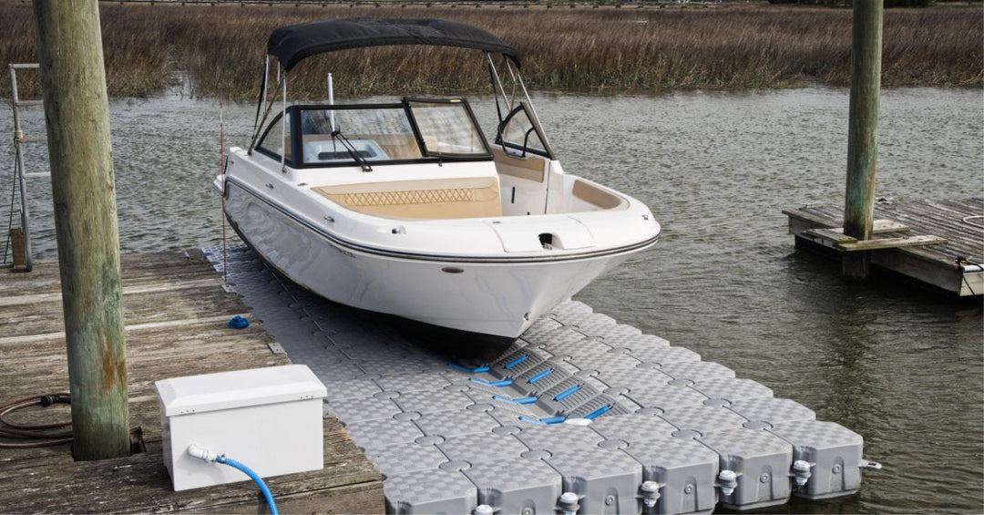Close-up of a personal watercraft resting on a modular floating dock, highlighting integrated rollers and stable support.